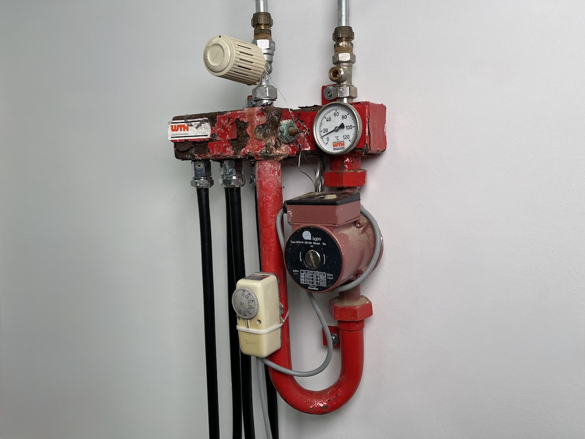 verroeste vloerverdeler met zwarte tyleen buizen vervuild systeem